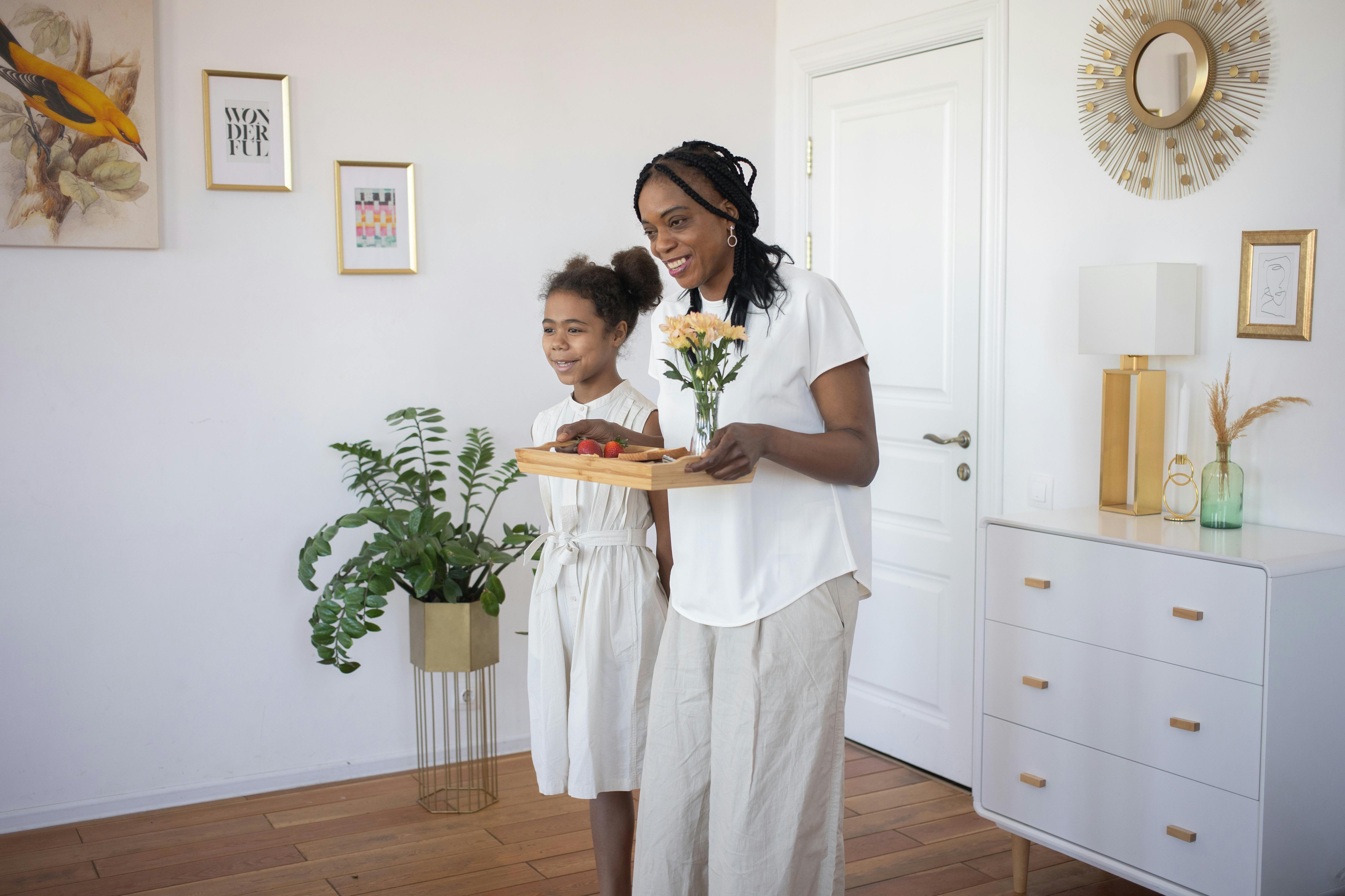 adults day care near me - A smiling mother and daughter carrying a tray with flowers in a stylish and cozy home environment.