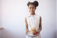 Girl in White Sleeveless Dress Holding White Cake