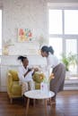 Man in White Dress Shirt Sitting on Yellow Couch