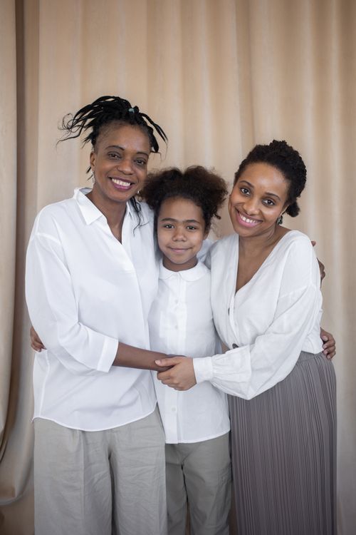 Women and child sharing a close family embrace