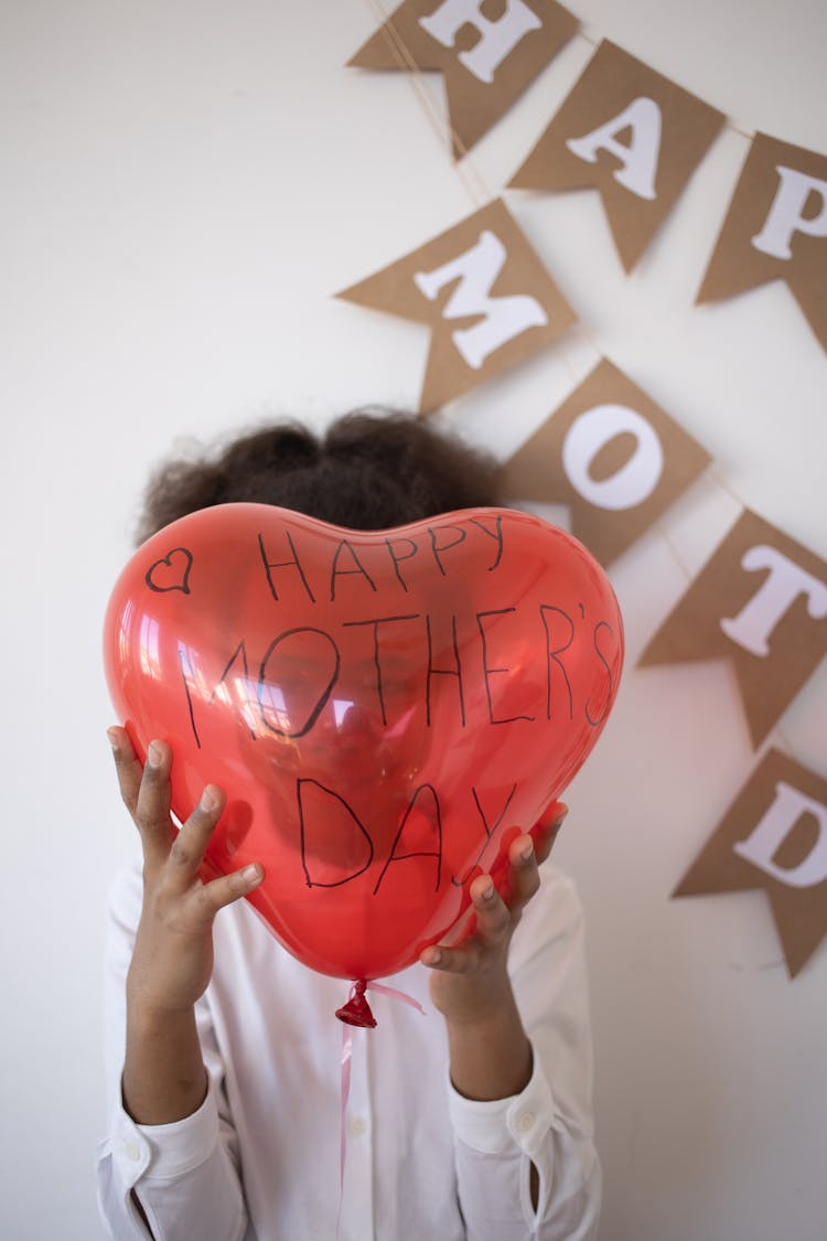 Child With Balloon With Wishes For Mothers Day