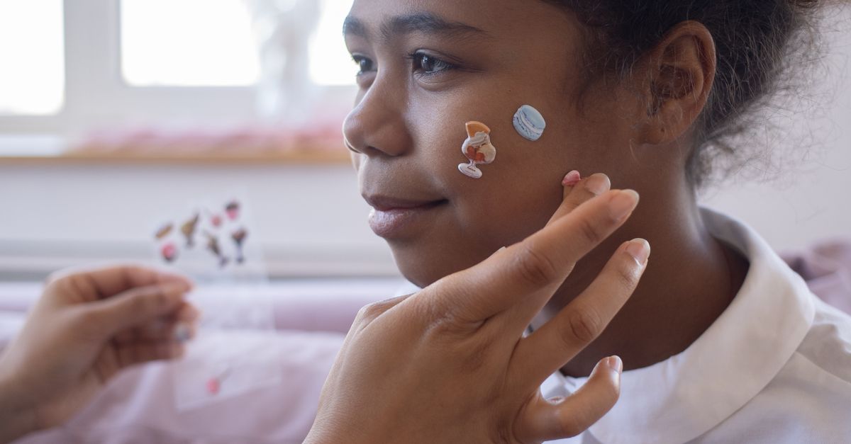People Using Stickers A Person Putting Stickers on the Girl's Face · Free Stock Photo