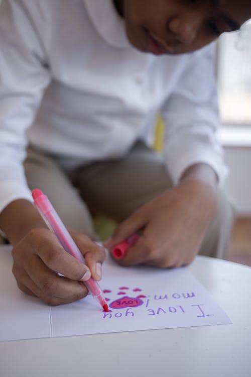 Free Kid Writing on a Paper Stock Photo
