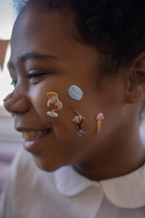 A Child with Face Stickers · Free Stock Photo