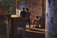 A Problematic Man Sitting on an Alleyway