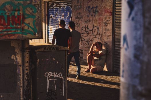 A Problematic Man Sitting on an Alleyway