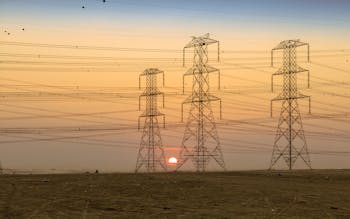 Silhouette of Electric Towers During Sunset