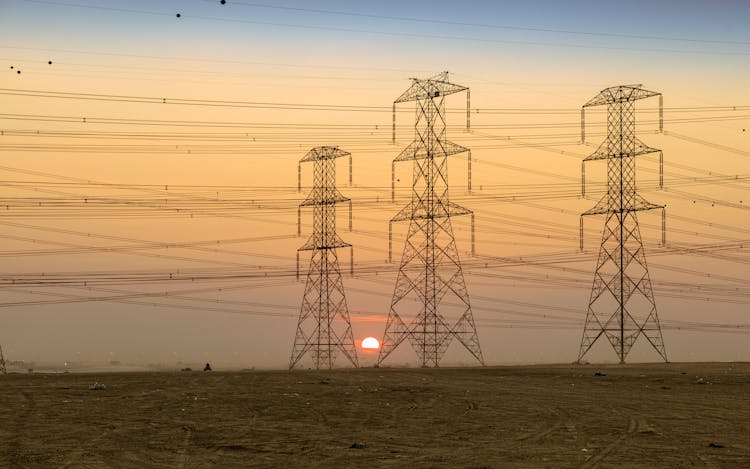 Silhouette Of Electric Towers During Sunset