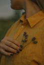 Person in Yellow Button Down Shirt Holding Flower