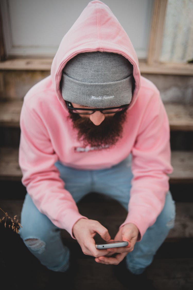 A Man Wearing A Pink Hoodie Sweater