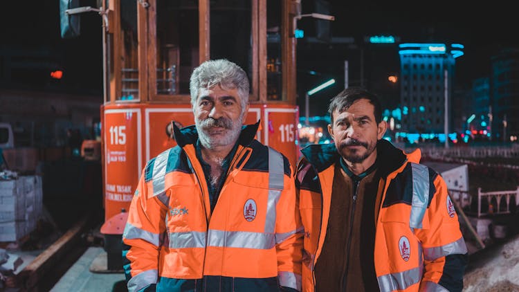 Construction Workers Standing Beside A Train