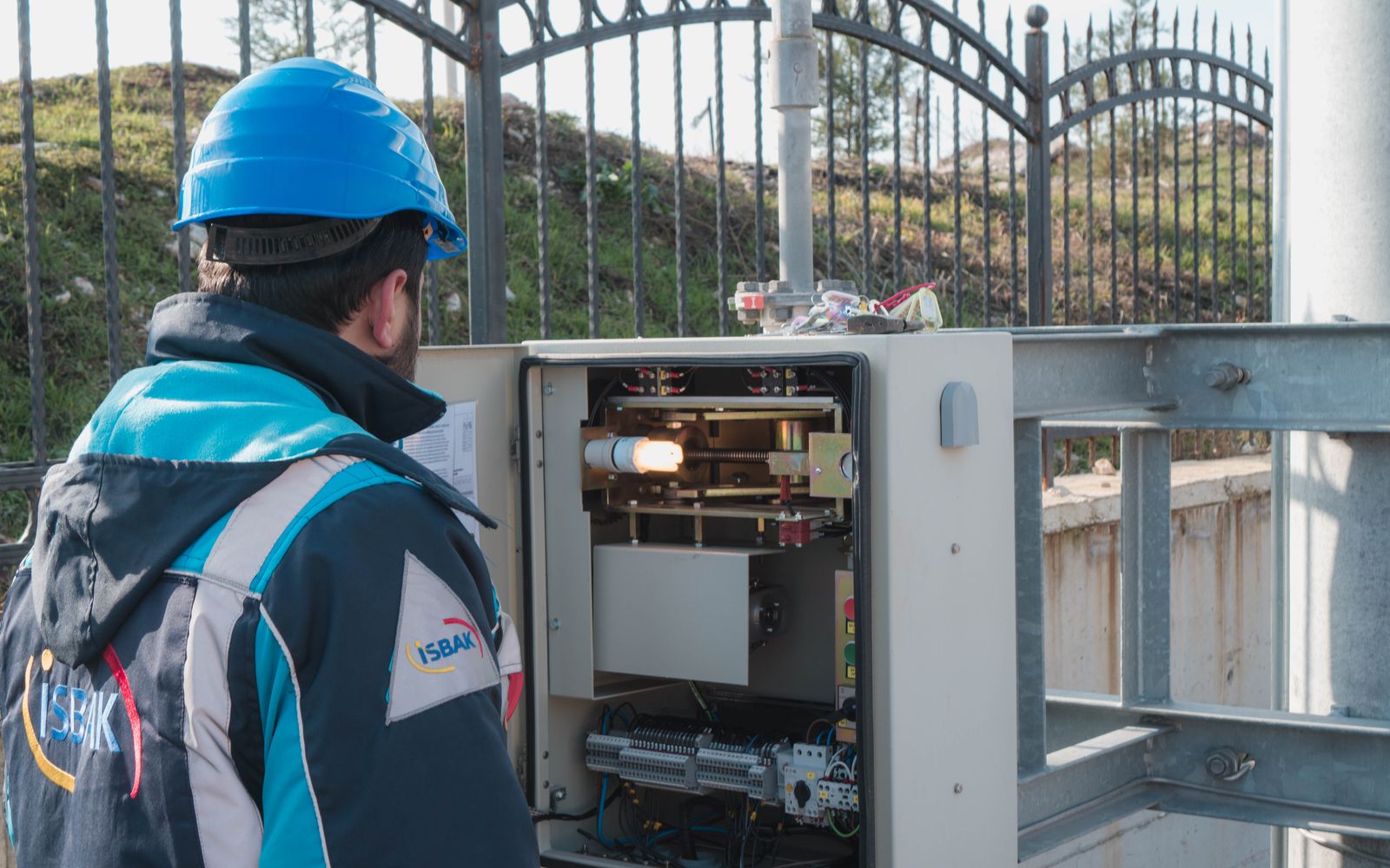 Licensed electrician inspecting a commercial fuse panel