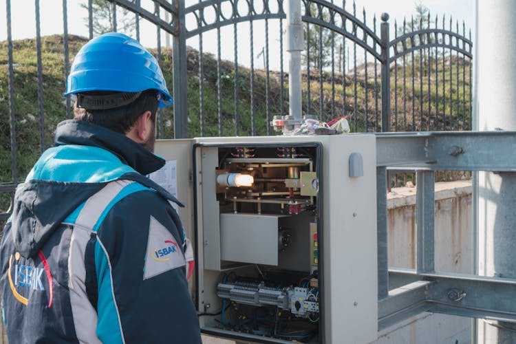 An Electrician Inspecting A Fuse Box