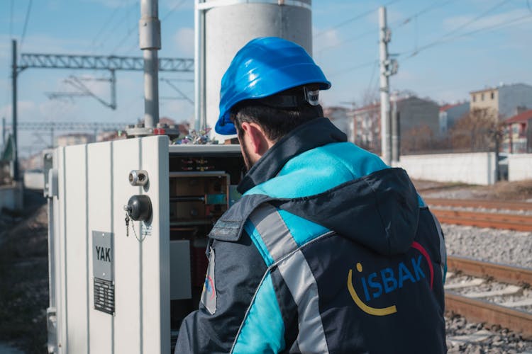 An Electrician Inspecting A Fuse Box