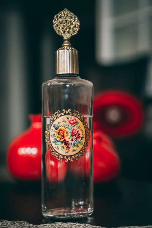 Free A beautifully designed glass bottle adorned with intricate floral patterns and a golden top in Istanbul, Turkey. Stock Photo
