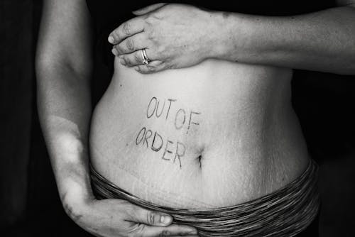 Free Out of Order Text on Persons Belly Stock Photo