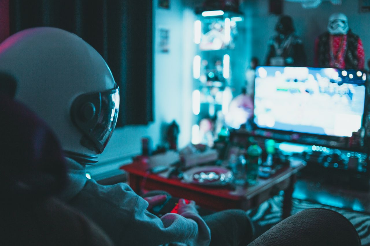 side view of unrecognizable person in virtual reality helmet sitting o