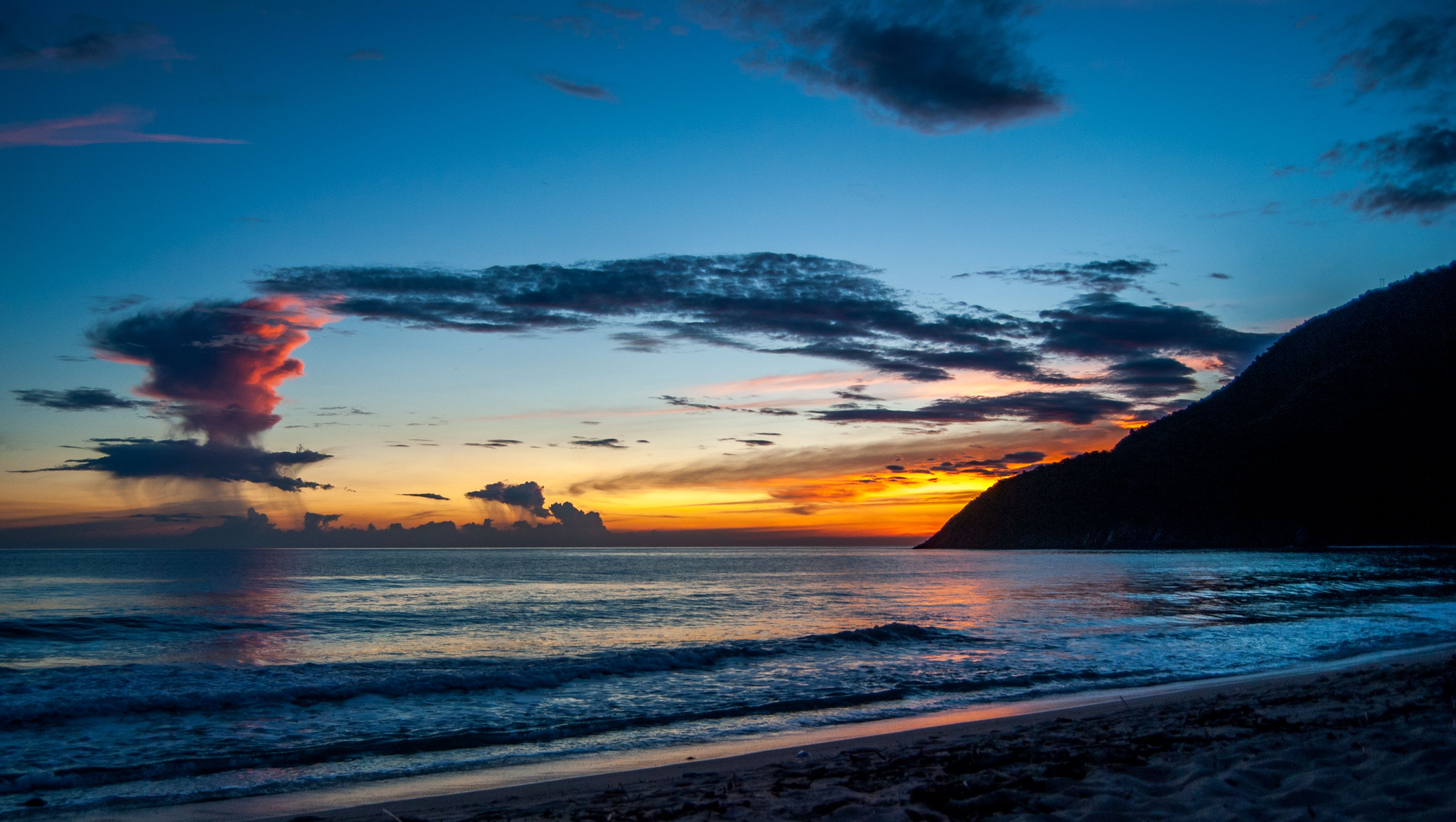 Experience a serene sunset at Cuyagua Beach in Aragua, Venezuela with vibrant skies.