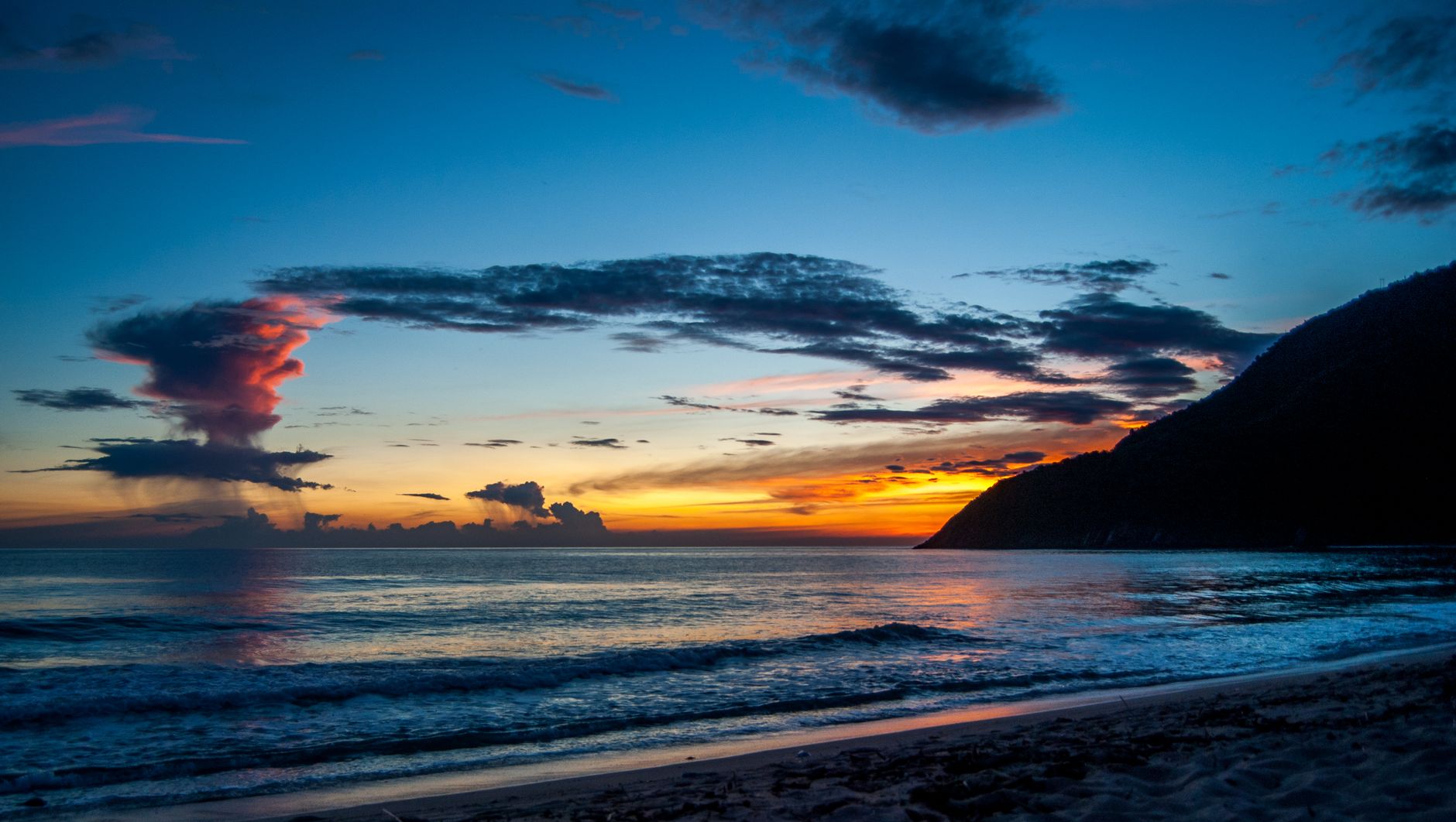 Experience a serene sunset at Cuyagua Beach in Aragua, Venezuela with vibrant skies.