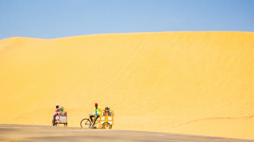 People Riding Bicycles on Desert