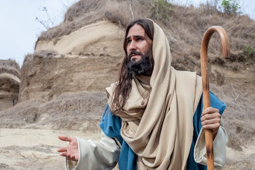Free A Man in Brown Robe Holding a Shepherd's Crook Stock Photo