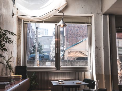A quiet dining area in a Seoul restaurant with a view outside, creating a cozy atmosphere.