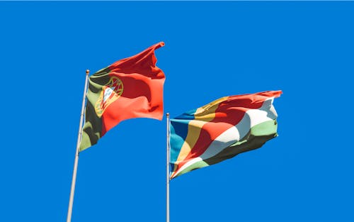 Portugal Flag and Seychelles Flag Under Blue Sky