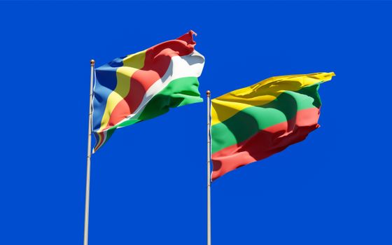 Colorful flags of Seychelles and Lithuania waving under a clear blue sky., free online jigsaw puzzle on JigsawPuzzlesFreeOnline.org