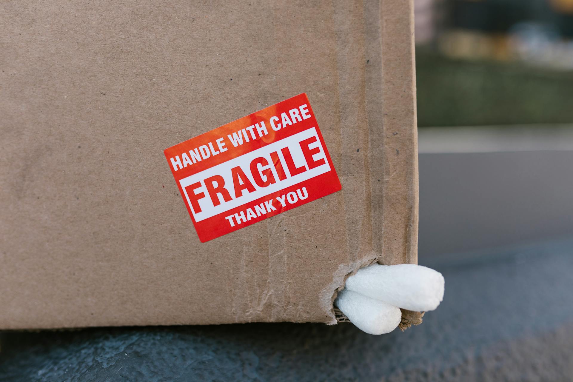 Brown Cardboard Box With Red and White Label