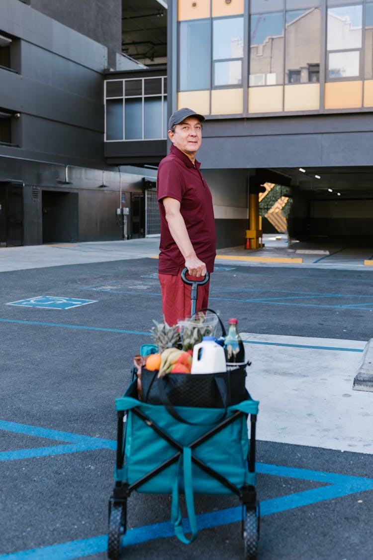 A Man Pulling A Trolley Of Food