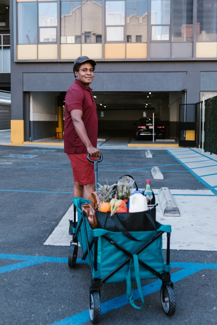 A Man Pulling A Trolley Of Food 