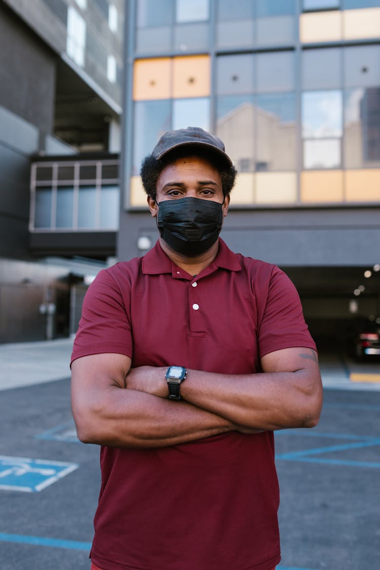 A Man In Maroon Shirt Wearing A Face Mask