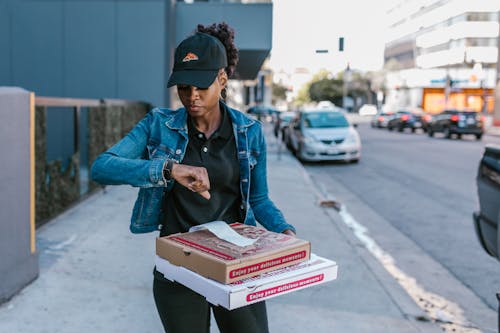 A Deliverywoman Looking at the Time