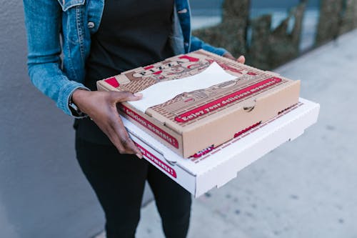 A Deliverywoman Holding Pizza Boxes