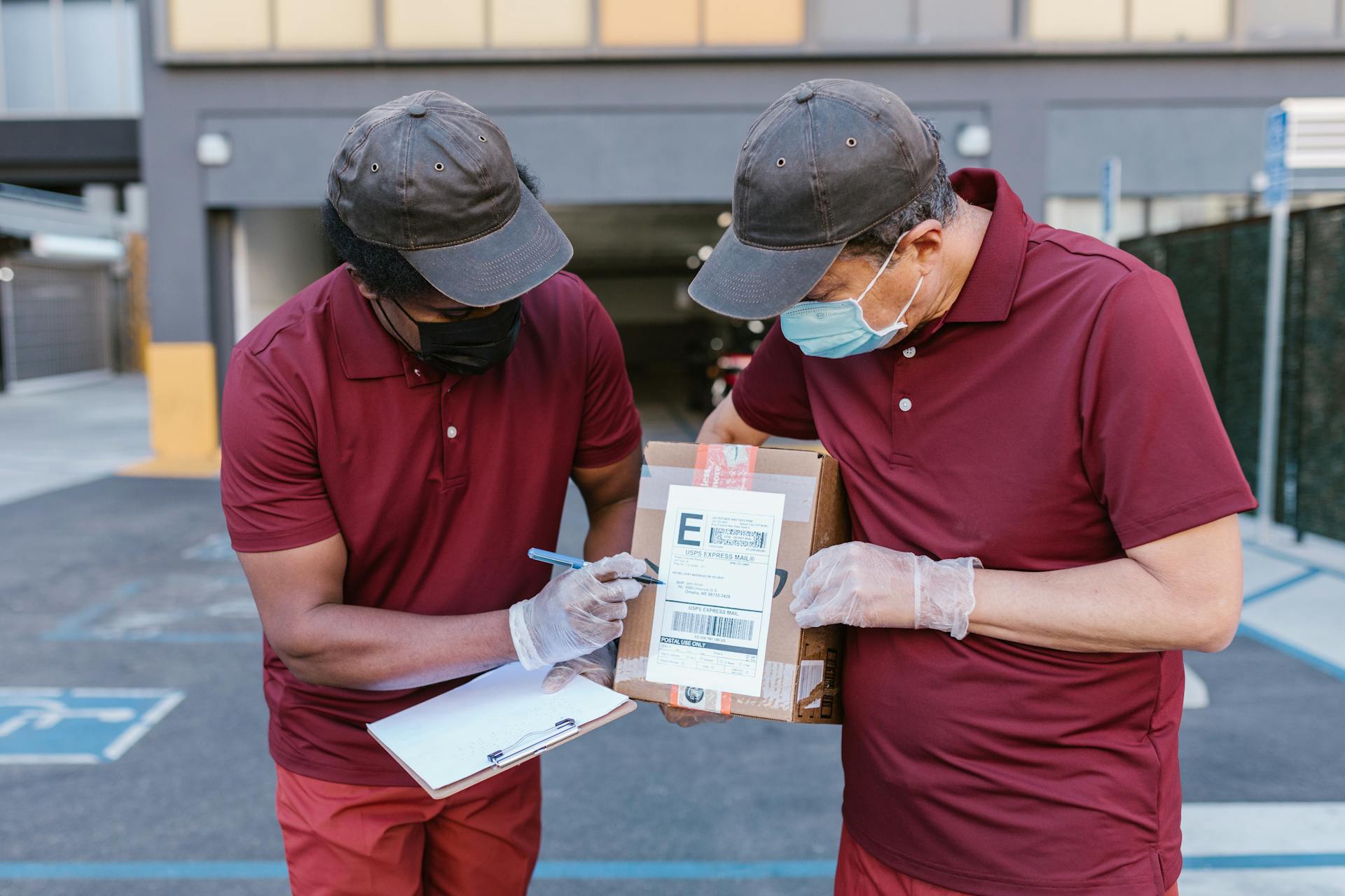 Men in Red Polo Shirt Checking the Shipping Label