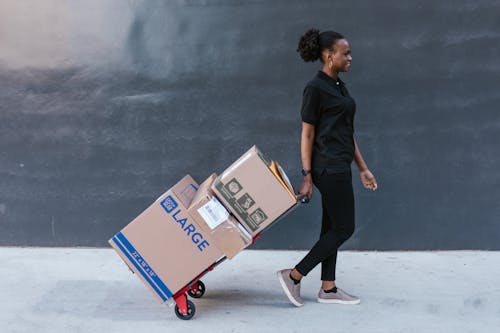 Man in Black Shirt Delivering the Boxes