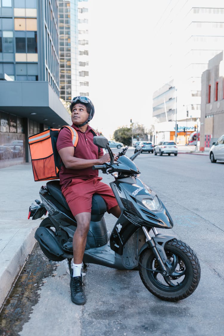 Man With Food Delivery Bag Riding A Motorcycle 