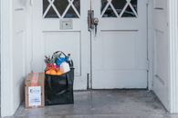 Black and Gray Backpack Beside White Wooden Door