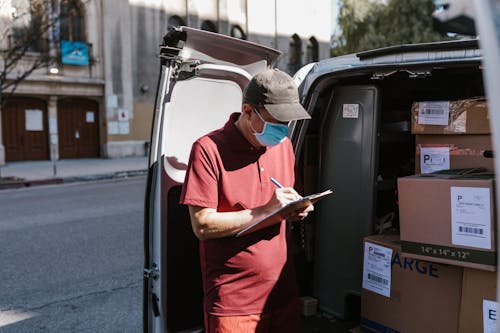 Free Delivery Man Writing a Receipt Stock Photo