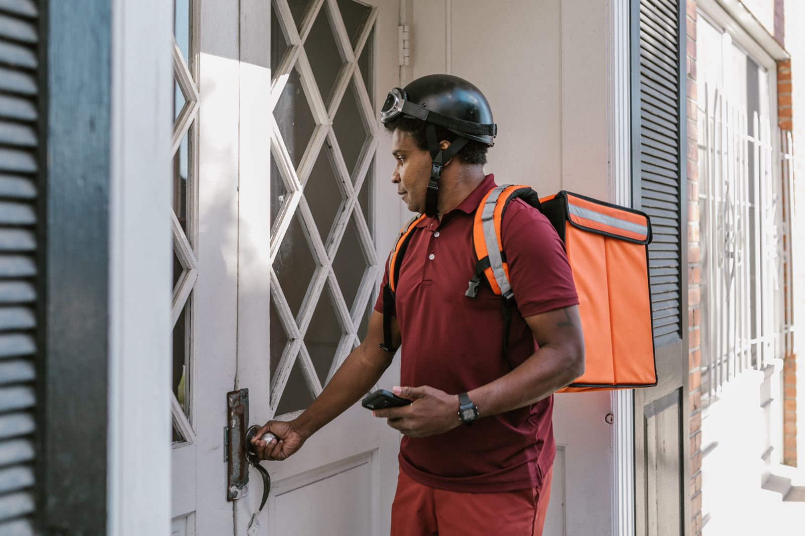 A food delivery worker managing a doorstep handoff