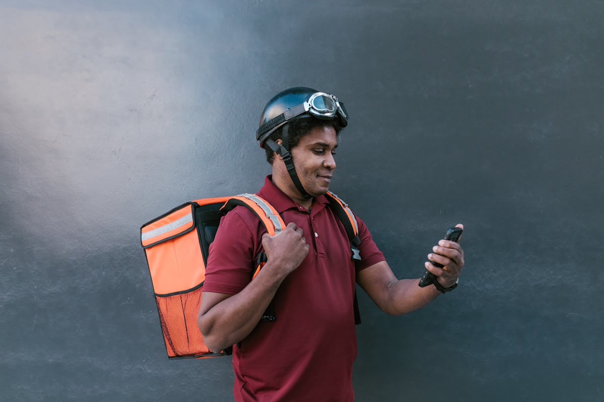 Photo of a Man Looking at His Cell Phone