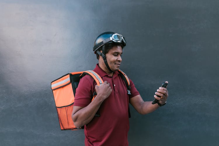 Photo Of A Man Looking At His Cell Phone