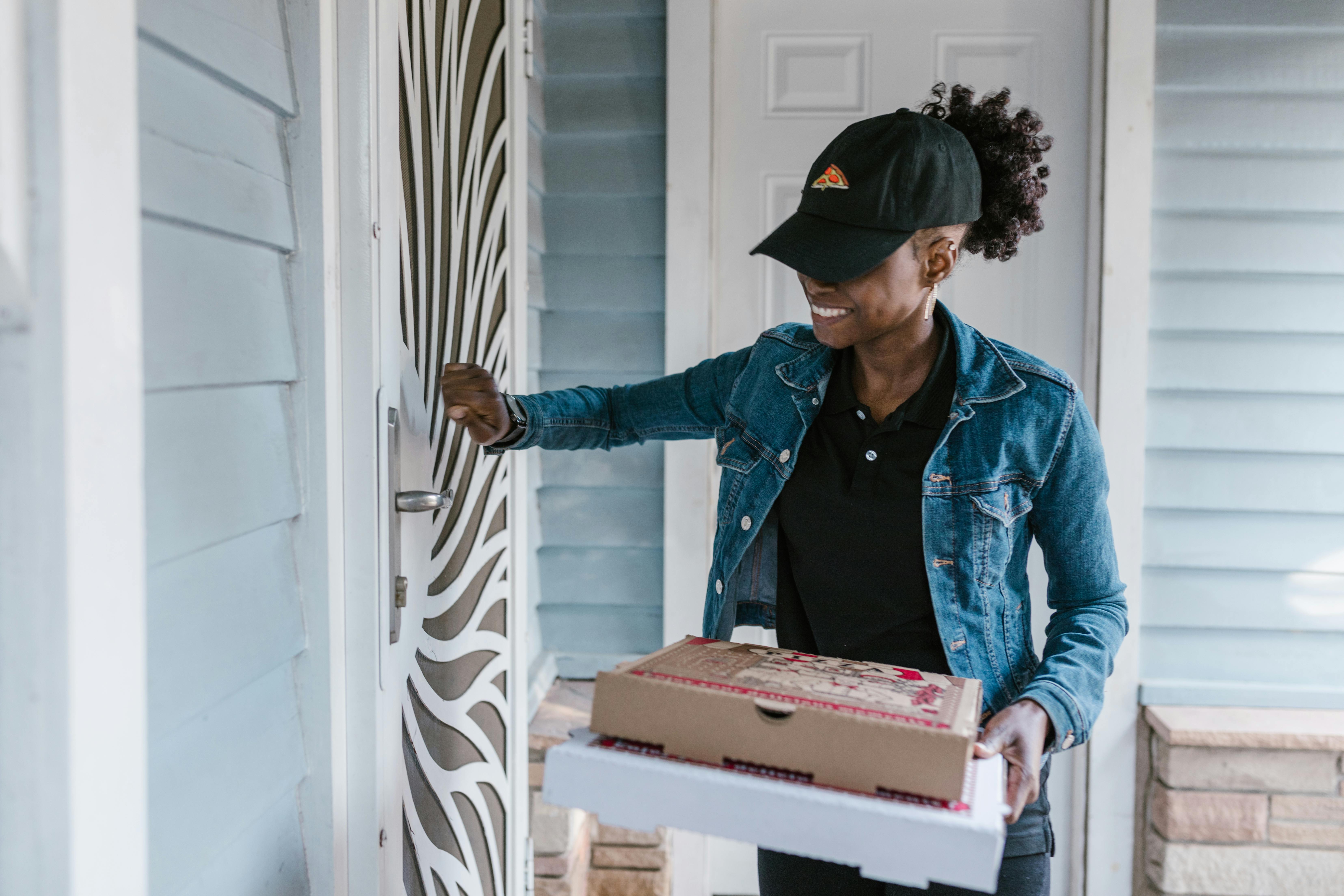 a deliverywoman knocking on the front door