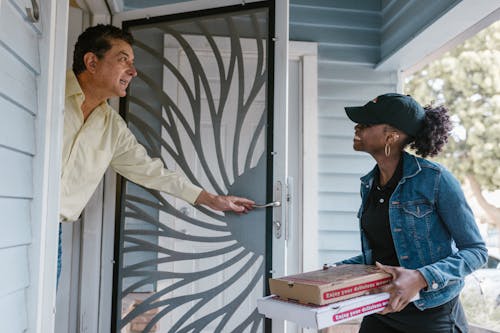 A Woman Delivering Boxes of Pizza