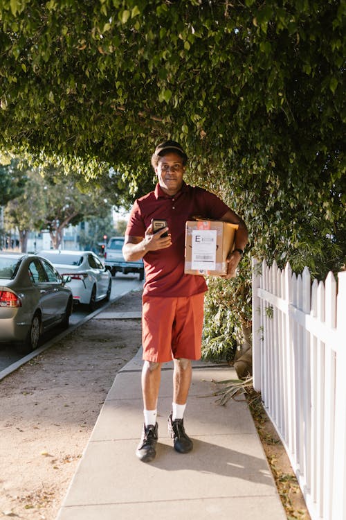 Free A Deliveryman Carrying a Package Stock Photo