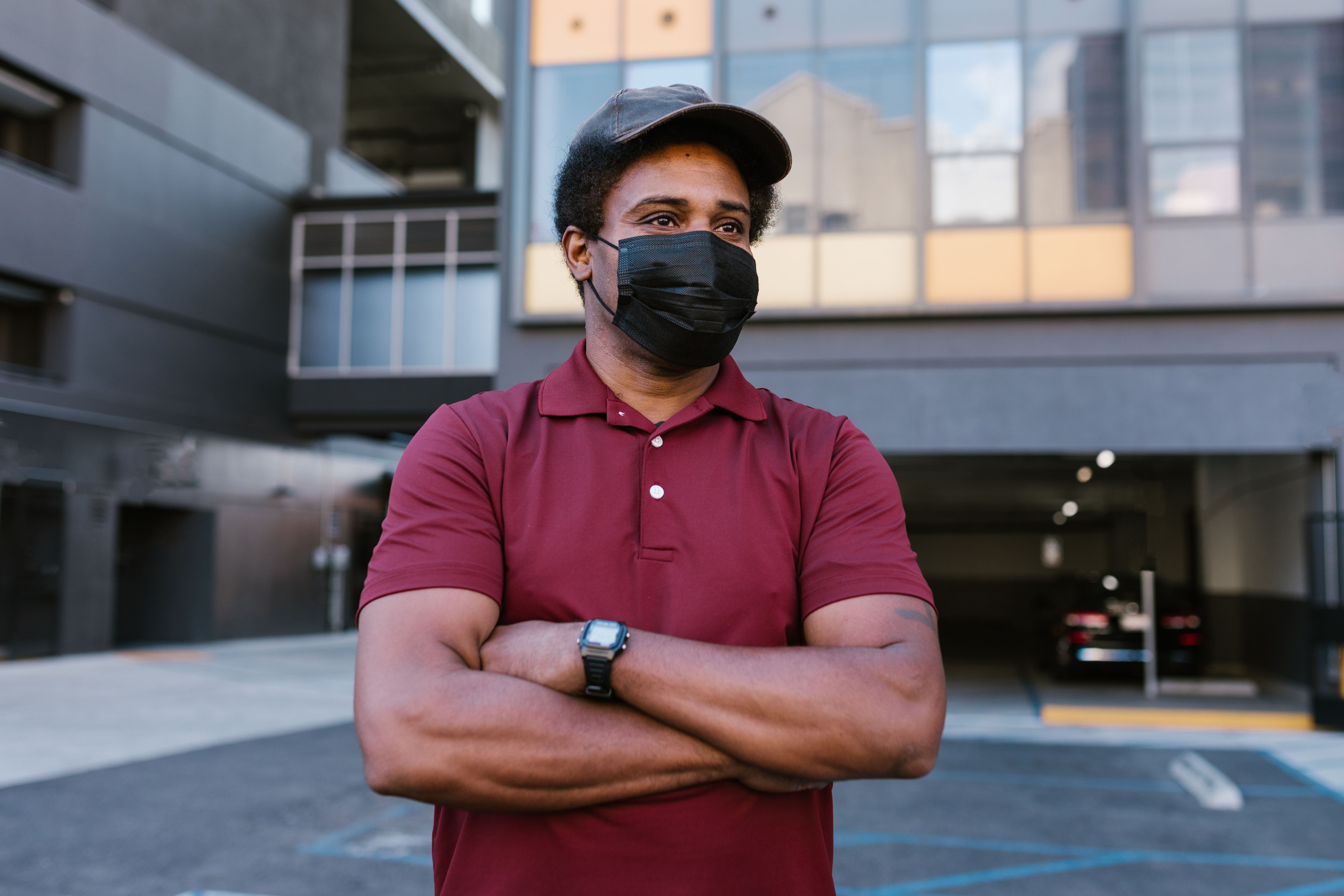 Man in Red Polo Shirt Standing outside a Building · Free Stock Photo