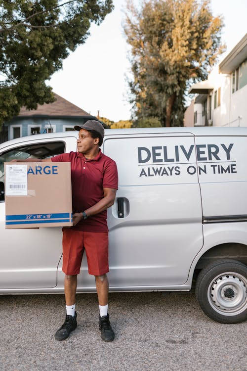 A Courier Carrying a Cardboard Box 