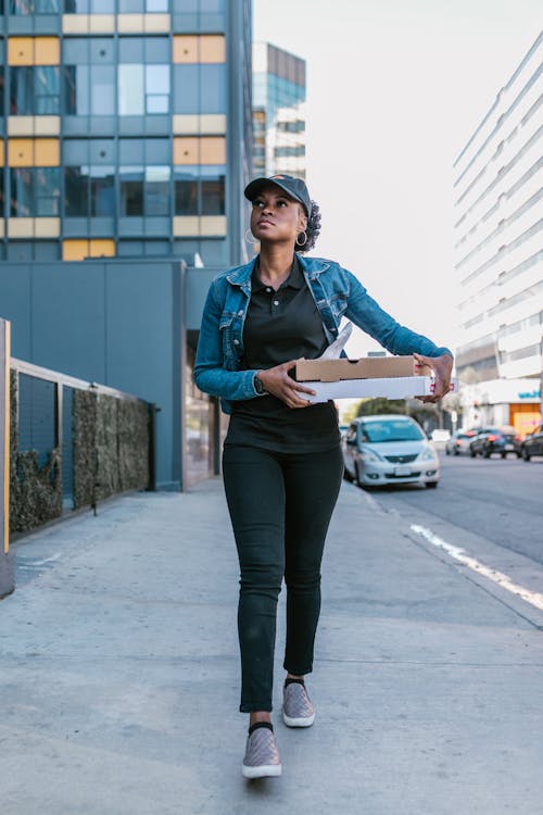 A Deliverywoman Carrying Pizza Boxes