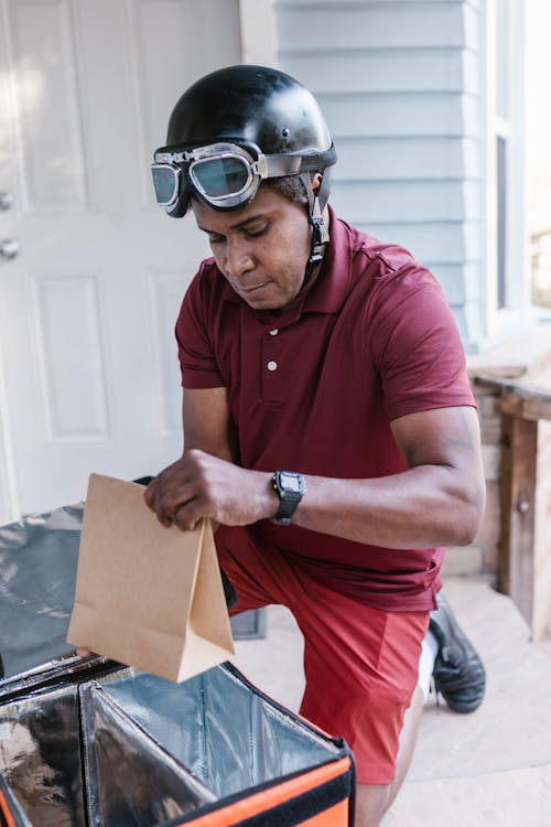 Free A Deliveryman Holding a Brown Paper Bag Stock Photo
