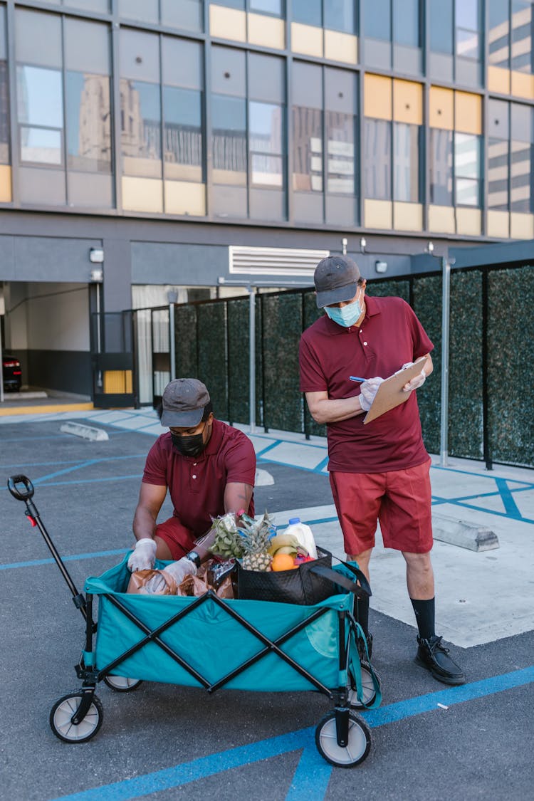 Men Making List Of Fresh Fruits Delivery